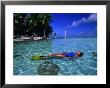 Woman In Blue Bathers Floating On Back In Tropical Water, French Polynesia by Michael Aw Limited Edition Print