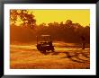 Man And Golf Cart Silhouetted At Sunset by Bill Bachmann Limited Edition Print