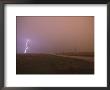Cloud-To-Ground Lightning Strikes A Field And Brightens A Foggy Sky by Peter Carsten Limited Edition Print