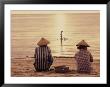 Women Sitting On Beach With Man Fishing, Indonesia by Bonnie Kamin Limited Edition Pricing Art Print