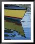 The Bow Of An Anchored, Striped Boat Is Reflected On The Water by Michael Melford Limited Edition Pricing Art Print
