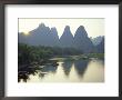 In Guilin Limestone Tower Hills Rise Steeply Above The Li River, Yangshuo, Guangxi Province, China by Anthony Waltham Limited Edition Print