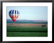 Colorful Hot Air Balloons Float Over A Wheat Field In Walla Walla, Washington, Usa by William Sutton Limited Edition Print