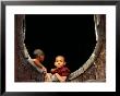 Two Young Novice Monks At Monastery Window, Myanmar by Anthony Plummer Limited Edition Print