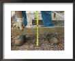 Man Measures A Wood Frame Before Pouring Concrete by Joel Sartore Limited Edition Print