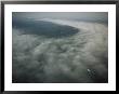Small Plane Dwarfed By An Immense Cloud Formation by Michael Nichols Limited Edition Print