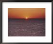 A Brillant Orange Sun Dips Behind The Mediterranean Sea by James L. Stanfield Limited Edition Print