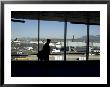 A Silhouette Walks Past A Window Looking Out At The Tarmac, Vancouver, British Columbia, Canada by Taylor S. Kennedy Limited Edition Print