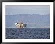 Oil Rig In The Santa Barbara Channel And The Santa Ynez Mountains, California by Rich Reid Limited Edition Print