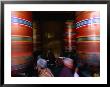 Pilgrims Turning Giant Prayer Wheels In The National Chorten Of Thimphu, Thimphu, Bhutan by Izzet Keribar Limited Edition Print