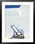 Deckchair Against Whitewashed Wall, Imerovigli, Santorini (Thira), Cyclades Islands, Greece by Lee Frost Limited Edition Print