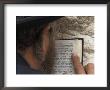An Orthodox Jew Holding Prayer Book Against The Wall And Praying, Western Wall, Jerusalem, Israel by Eitan Simanor Limited Edition Print