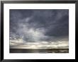 Sun Streams Through Gathering Storm Clouds On North Carolina Coast by David Evans Limited Edition Print