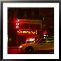 Taxi Passing A Neon Lit Bar, New York City, United States Of America by Corey Wise Limited Edition Print