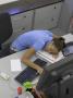 Office Life And Interiors, Young Woman Slumped On Desk by Richard Bryant Limited Edition Print