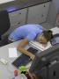 Office Life And Interiors, Young Woman Slumped On Desk by Richard Bryant Limited Edition Print