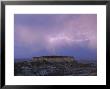 Lightning Strikes Above A Butte In Adobe Town In Wyoming's Red Desert by Joel Sartore Limited Edition Print