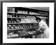 Good Of Worker In Bakery Standing In Front Of Shelves Of Various Kinds Of Breads And Rolls by Alfred Eisenstaedt Limited Edition Pricing Art Print