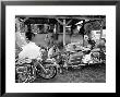 Black Motorcyclist Of The Big Circle Motorcycle Association Sitting Between Harley Davidson Bikes by John Shearer Limited Edition Print