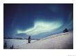 The Aurora Borealis Creates A Fantastic Swirl Of Light Over The Snowy Landscape by Paul Nicklen Limited Edition Print