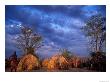 Mursi Huts Protect Tenants From The Oncoming Storm, Ethiopia by Janis Miglavs Limited Edition Print