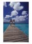 Couple Running On Dock, Curacao, Caribbean by Greg Johnston Limited Edition Print