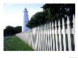 The Lighthouse Stands Behind A Fence On Ocracoke Island by Stephen Alvarez Limited Edition Print