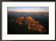 Low Sunlight Shines On Mountains Outside Of St. George, Utah; Zion National Park Is In The Distance by Melissa Farlow Limited Edition Print