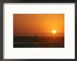 A Man Surfs As The Sun Sets On The Pacific Ocean, Baja, Mexico by Jimmy Chin Limited Edition Pricing Art Print