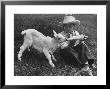 Little White Goat Being Fed From Bottle By Little Boy, At White Horse Ranch by William C. Shrout Limited Edition Print
