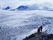 Hikers Looking Over Exit Glacier And Harding Ice Field, Kenai Fjords National Park, Usa by Brent Winebrenner Limited Edition Pricing Art Print