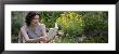 Young Woman Reading A Book In A Garden In A Garden by Panoramic Images Limited Edition Pricing Art Print