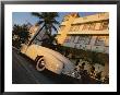 An Antique Car Parked Outside The Art Deco-Style Avalon Hotel by Annie Griffiths Belt Limited Edition Pricing Art Print