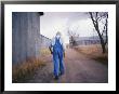 An Elderly Farmer In Overalls Walks Along A Dirt Road Past A Barn by Joel Sartore Limited Edition Print