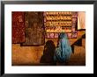 Woman In Sari Sitting In Front Of Rugs For Sale, Jaisalmer, Rajasthan, India by Dallas Stribley Limited Edition Print