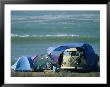 Campsite On Oceans Edge With Tents, Vw Camper And Surfer In A Chair by Skip Brown Limited Edition Print