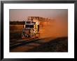 Road Train Driving Along Dusty Road, Kynuna, Australia by Holger Leue Limited Edition Print