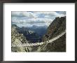 A Man Walking Across A Bridge In The Dolemites, Cortina, Italy by Ed George Limited Edition Print