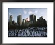 Elevated View Of Ice Skaters In Central Park And Of The Surrounding Cityscape by Ira Block Limited Edition Print