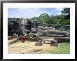 Two Monks In Front Of Buddha Statue, Gal Vihara, Polonnaruwa, Unesco World Heritage Site, Sri Lanka by Yadid Levy Limited Edition Print