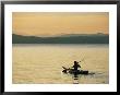 A Kayaker Paddles Across Lake Sebagos Calm Waters In Low Sunlight by Skip Brown Limited Edition Print