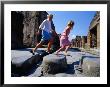 Mother And Daughter Crossing Ancient Street, Pompeii, Italy by Philip & Karen Smith Limited Edition Pricing Art Print