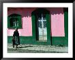 Elderly Woman Walking Past Pink And Green Building, Chiapas, Mexico by Eric Wheater Limited Edition Print