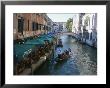 A Gondolier Passes A Restaurant On A Canal In Venice, Italy by Taylor S. Kennedy Limited Edition Print