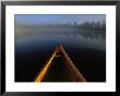 A Canoes Bow On Black Lake In Early Morning Light by Maria Stenzel Limited Edition Print