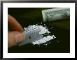 A Hand Dividing Up A Pile Of Cocaine With A Razor Blade by Todd Gipstein Limited Edition Print