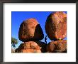 Man Standing In Between Boulders, Devil's Marbles Conservation Reserve, Australia by John Banagan Limited Edition Print