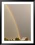 A Rainbow Arches Across The Sky Onto A Cluster Of Farm Buildings by Michael S. Lewis Limited Edition Print