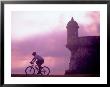 Cycling At El Morro In Old San Juan At Sunset, Puerto Rico by Greg Johnston Limited Edition Pricing Art Print