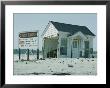 Sign Advertising A Housing Development Being Built Next To A Storm-Damaged Cottage by B. Anthony Stewart Limited Edition Print